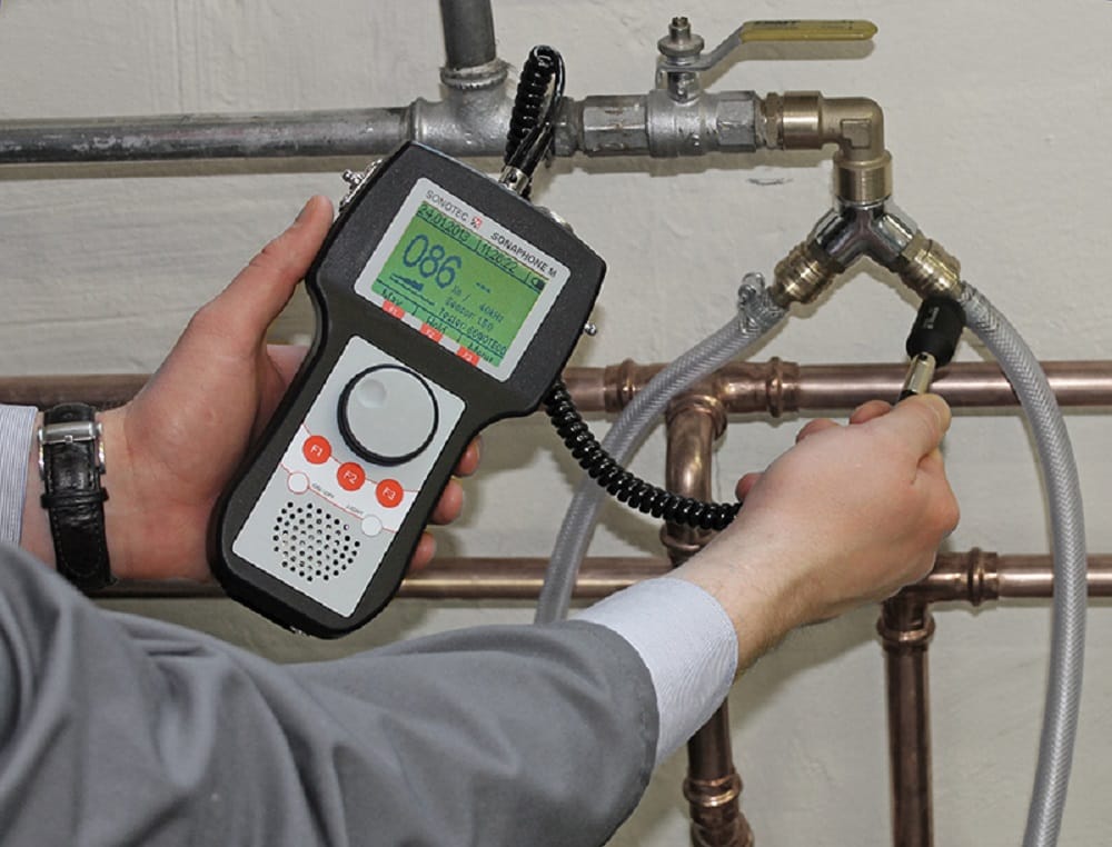 Plumber testing pipes with electronic leak detection equipment in Corvallis