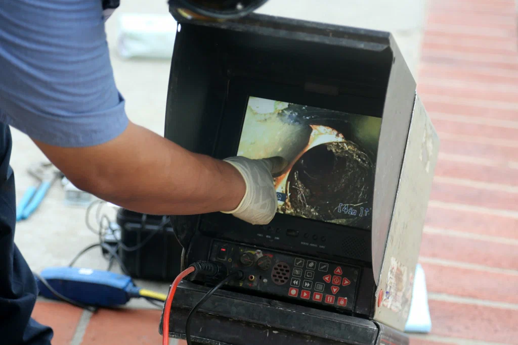 Technician viewing a drain inspection camera in Corvallis