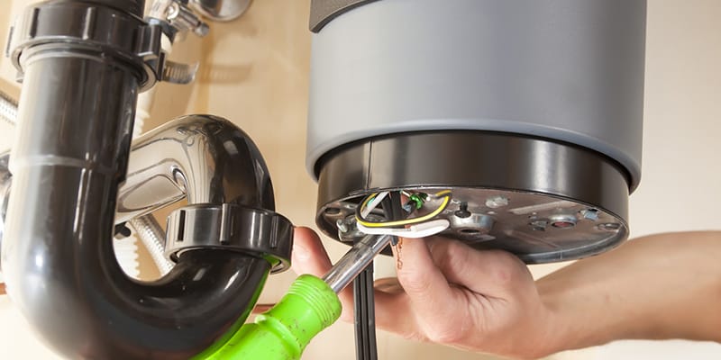 Technician repairing the heating element of a water heater in Corvallis