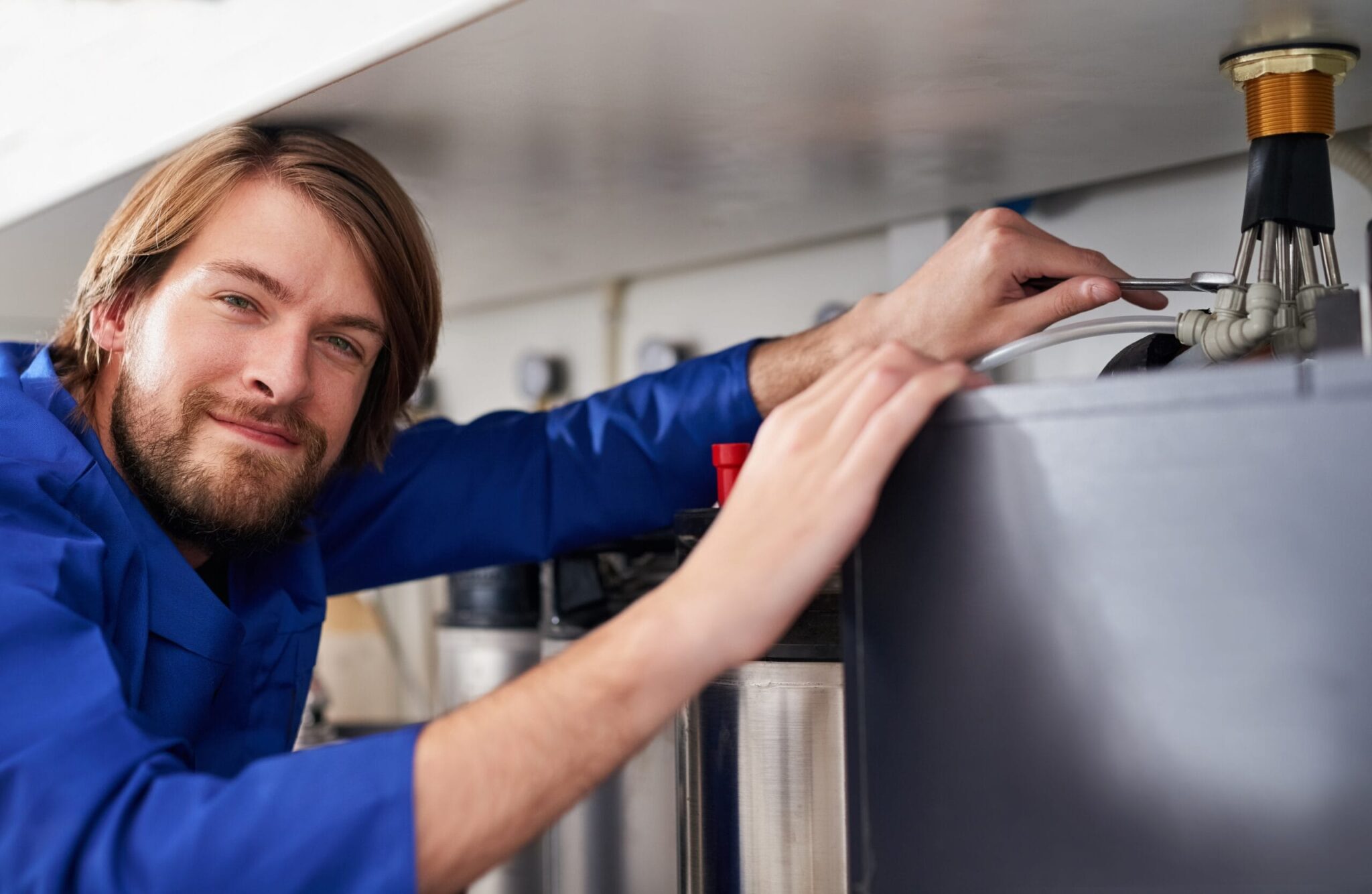 Technician servicing a residential water heater tank in Corvallis