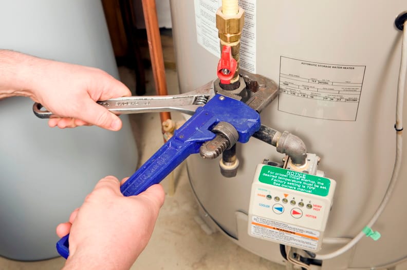 Plumber repairing a water heater valve in Corvallis